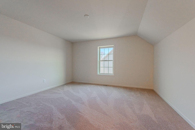 bonus room featuring light colored carpet, baseboards, and lofted ceiling