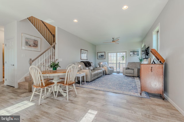 living room featuring recessed lighting, baseboards, wood finished floors, and stairs