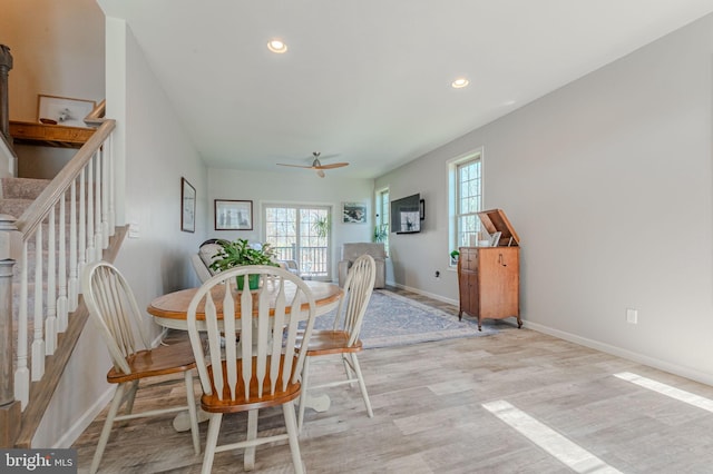 dining room featuring recessed lighting, baseboards, wood finished floors, and stairs