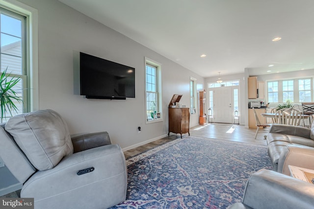 living room with recessed lighting, baseboards, and light wood-style flooring