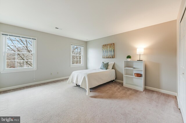 bedroom with light colored carpet