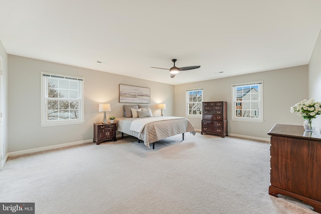 bedroom with light colored carpet and ceiling fan