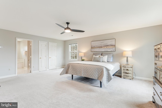 bedroom with connected bathroom, light colored carpet, a closet, and ceiling fan