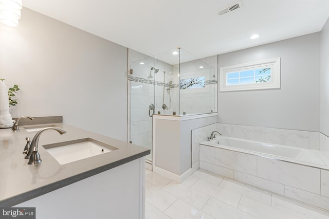 bathroom featuring plus walk in shower and vanity