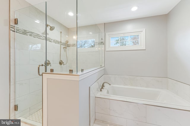 bathroom with separate shower and tub