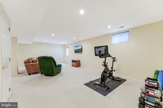 exercise room with light colored carpet