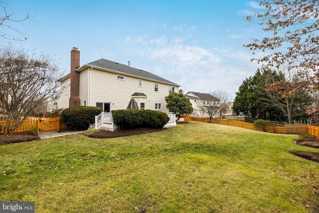 rear view of house with a lawn