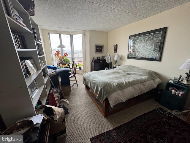 bedroom with carpet and a textured ceiling