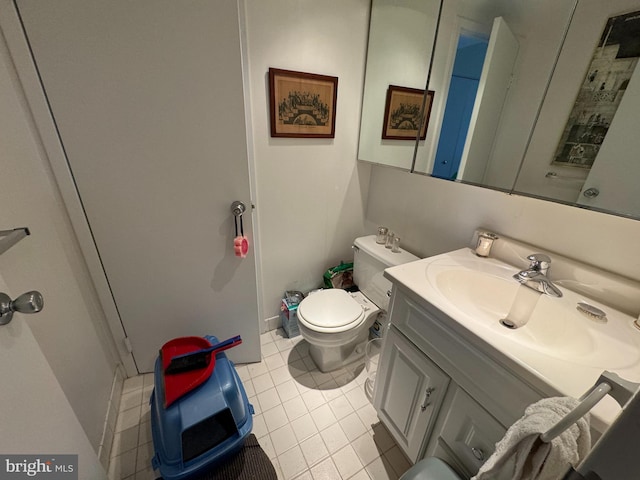 bathroom featuring vanity, tile patterned floors, and toilet