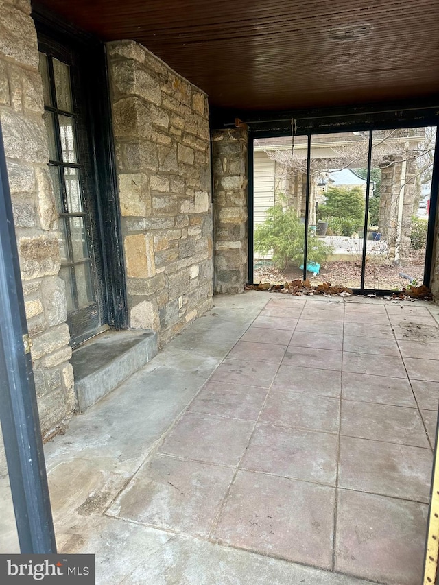 unfurnished sunroom featuring wood ceiling