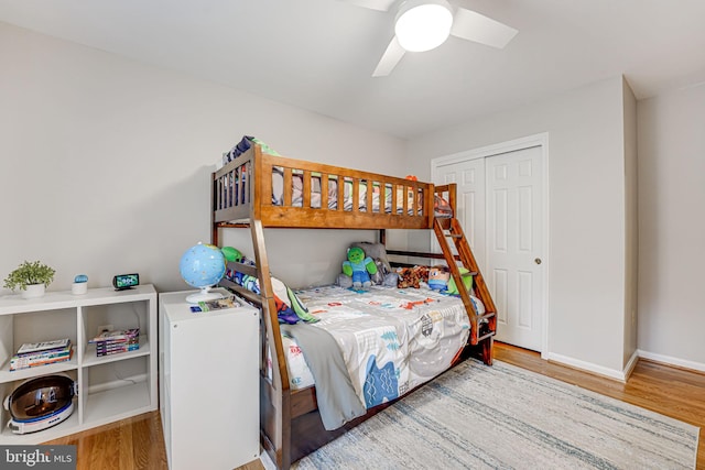 bedroom featuring ceiling fan, light wood-type flooring, and a closet