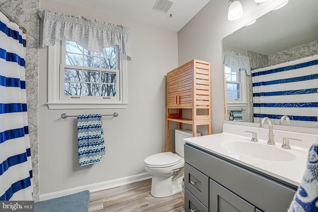 bathroom featuring hardwood / wood-style flooring, vanity, a shower with curtain, and toilet