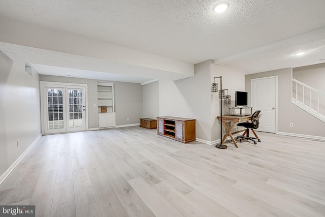 interior space featuring a textured ceiling and light wood-type flooring