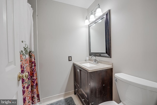 bathroom featuring vanity, tile patterned floors, and toilet