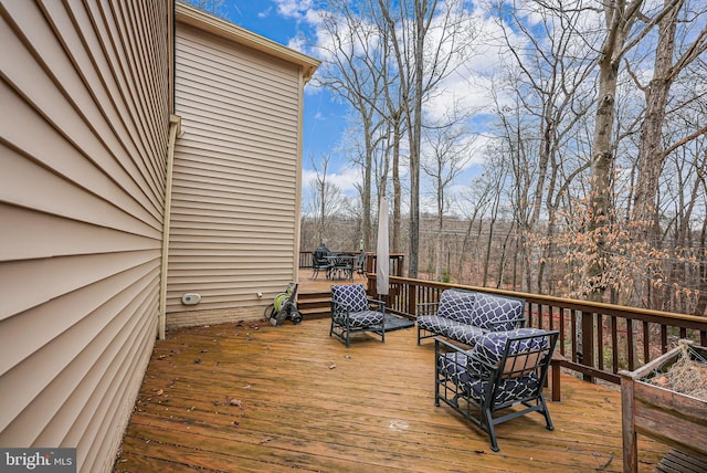 wooden terrace featuring an outdoor hangout area