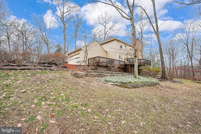 view of yard featuring a garage and a deck