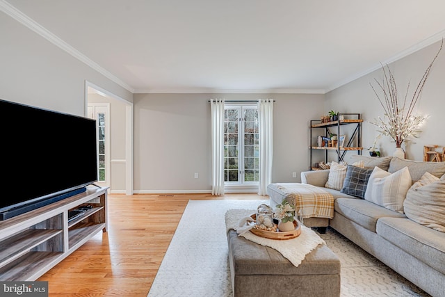 living room with crown molding and light wood-type flooring