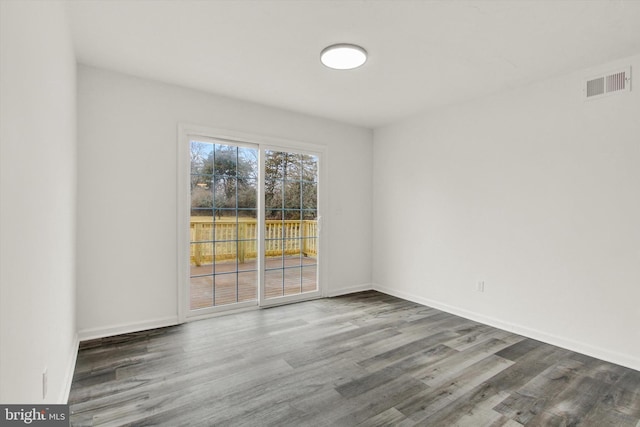 spare room with dark wood-type flooring