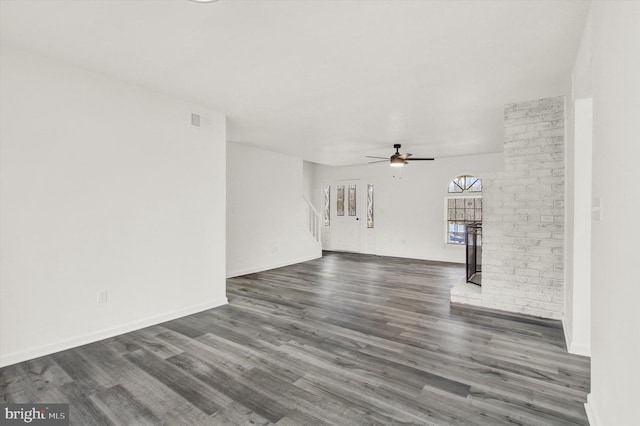 unfurnished living room featuring ceiling fan and dark hardwood / wood-style floors