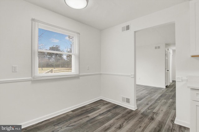 unfurnished room featuring dark hardwood / wood-style flooring