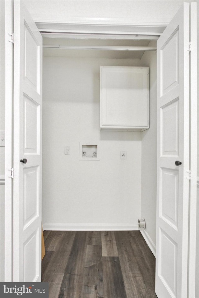 washroom with dark hardwood / wood-style flooring and hookup for a washing machine