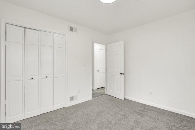 unfurnished bedroom with carpet floors and a closet