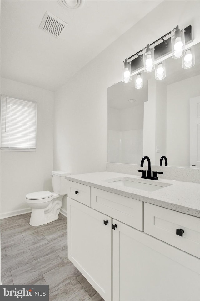 bathroom with vanity and toilet