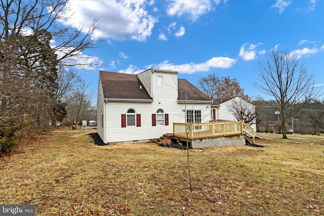 rear view of property with a lawn and a deck