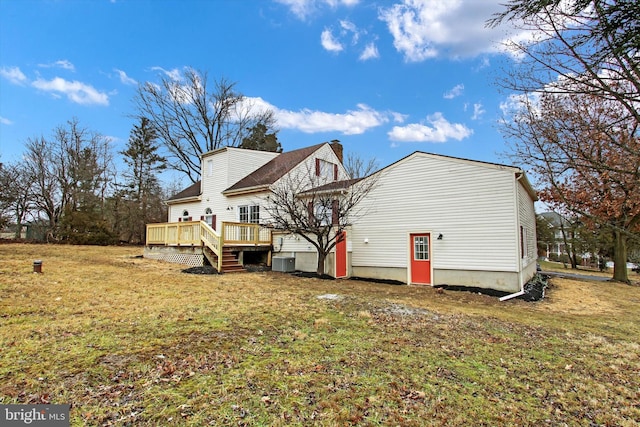 back of property featuring a wooden deck, a yard, and central air condition unit