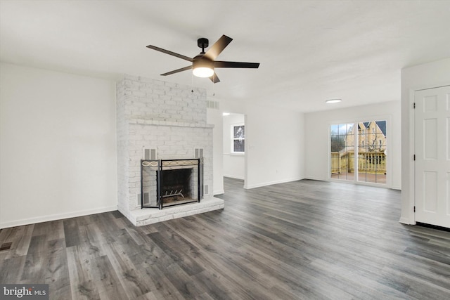 unfurnished living room with dark hardwood / wood-style flooring, ceiling fan, and a fireplace