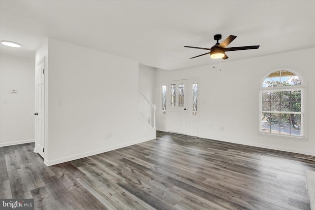 unfurnished room with dark hardwood / wood-style flooring and ceiling fan