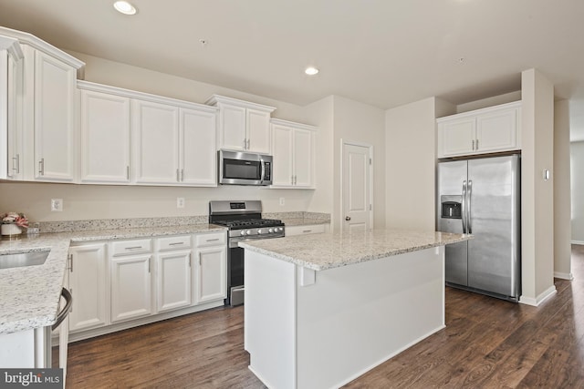 kitchen featuring dark wood-style floors, white cabinetry, appliances with stainless steel finishes, and recessed lighting