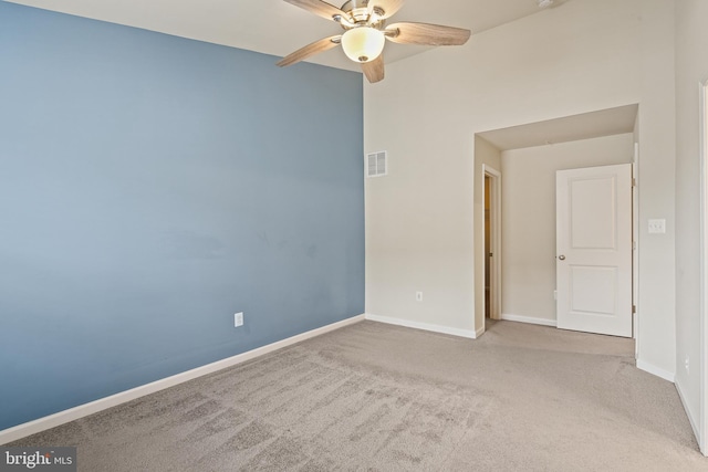 spare room featuring baseboards, visible vents, ceiling fan, and carpet flooring