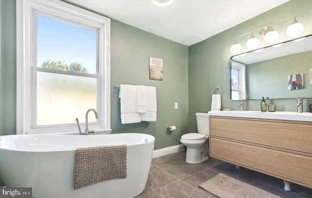 bathroom featuring vanity, toilet, and a bathing tub