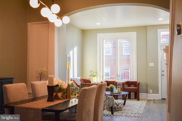 dining space with an inviting chandelier and hardwood / wood-style flooring