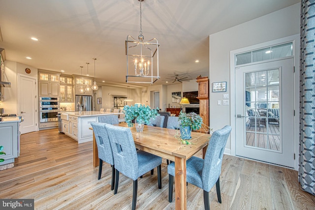 dining room featuring a chandelier and light wood-type flooring