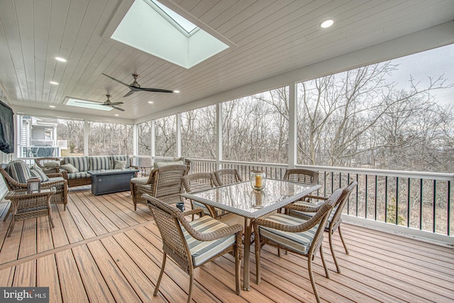 deck featuring outdoor lounge area and ceiling fan