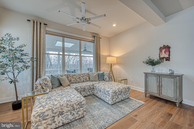 living room featuring light hardwood / wood-style flooring and ceiling fan