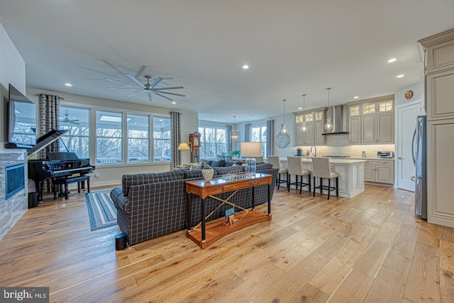 living room featuring ceiling fan and light wood-type flooring