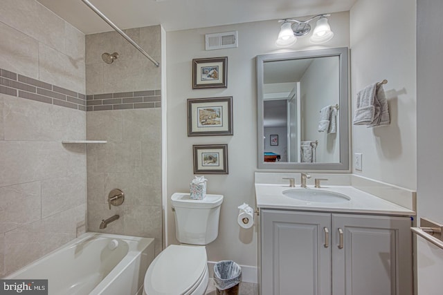 full bathroom with vanity, toilet, and tiled shower / bath