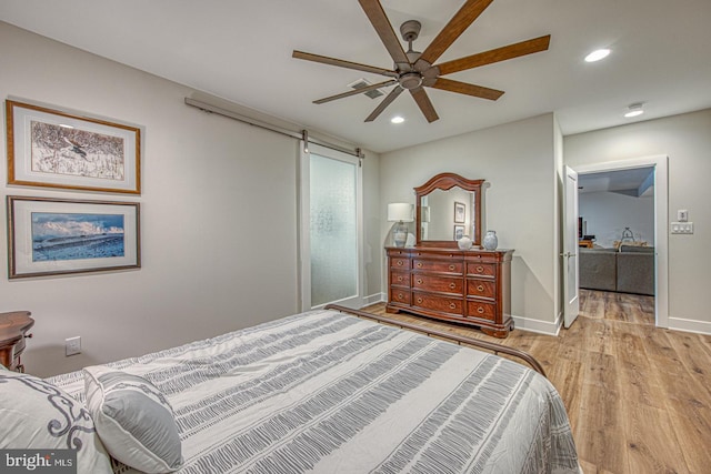 bedroom featuring ceiling fan and light hardwood / wood-style floors