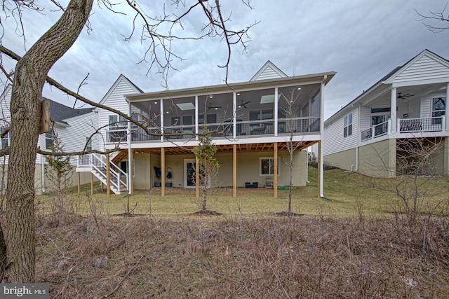 rear view of house featuring a lawn, a sunroom, ceiling fan, and a deck