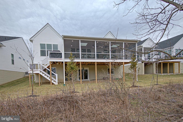 back of property featuring a sunroom, ceiling fan, and a deck