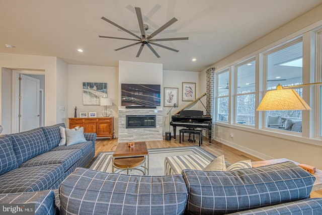 living room with wood-type flooring and ceiling fan