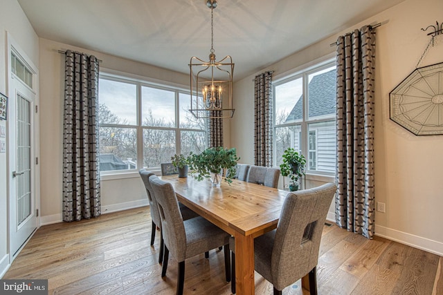 dining room featuring an inviting chandelier and light hardwood / wood-style flooring