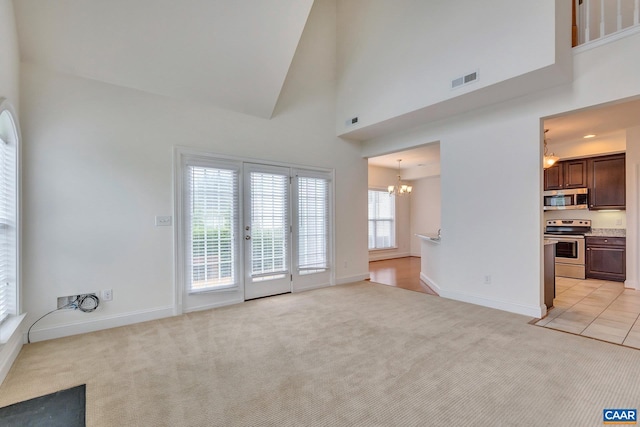 1305 Gate Post Ln, Charlottesville, VA 22901 - unfurnished living room with a high ceiling, light carpet, and a chandelier