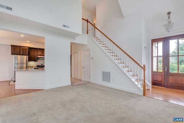 1305 Gate Post Ln, Charlottesville, VA 22901 - unfurnished living room featuring a towering ceiling and light carpet