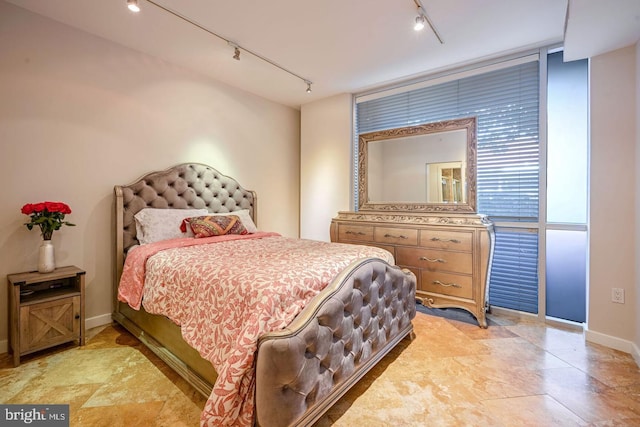 bedroom with floor to ceiling windows and rail lighting