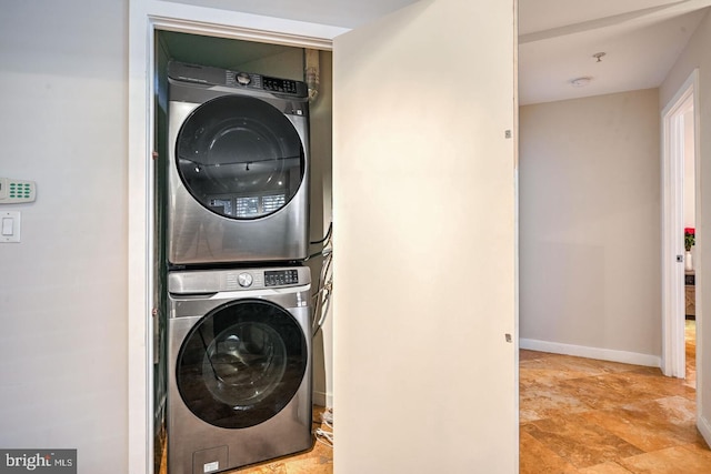 washroom with stacked washing maching and dryer