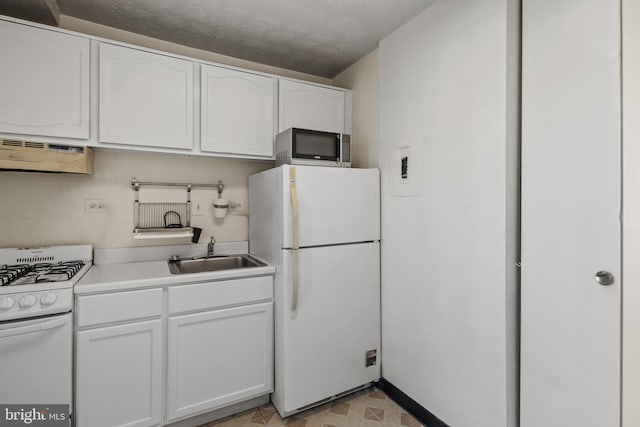 kitchen featuring white appliances, sink, and white cabinets